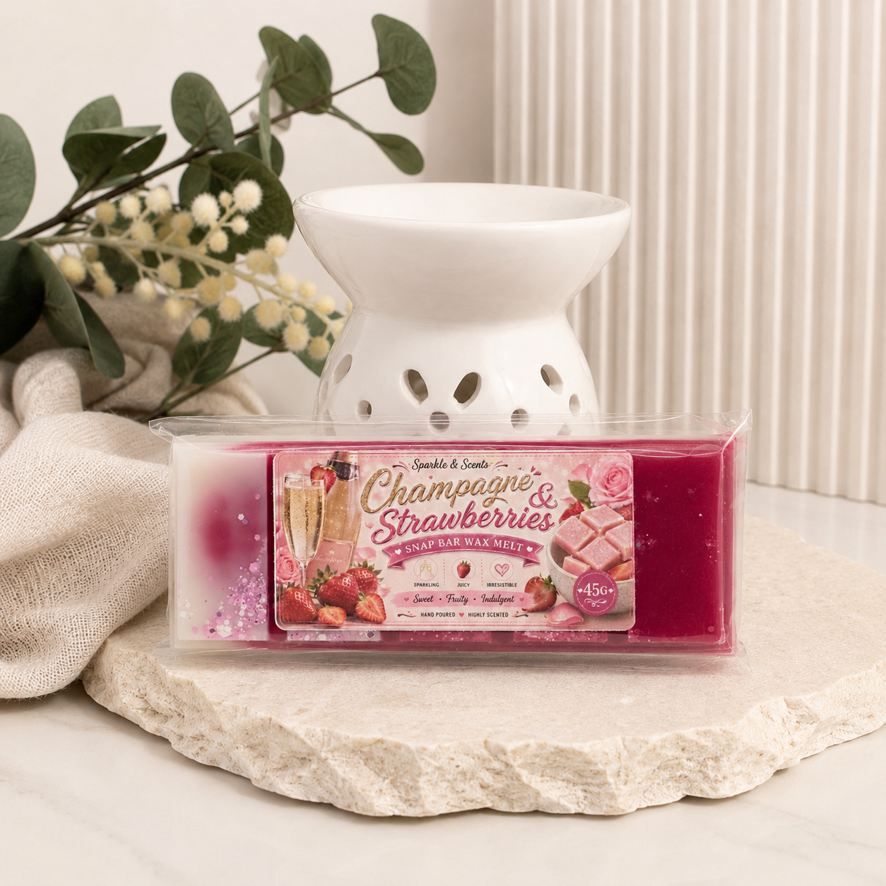 Wax melt container labeled 'Bubbles& Strawberries' with a decorative lamp on a neutral background.