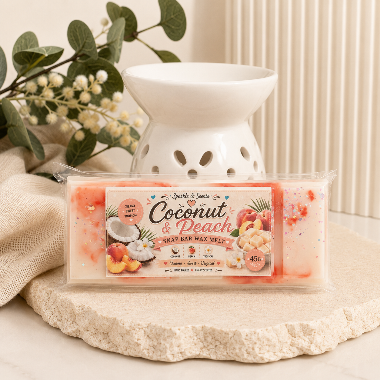 Coconut & Peach wax melt with a white wax warmer on a decorative stone surface.