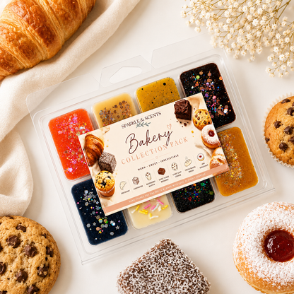 Bakery-themed wax melts packaging with various scents on a white surface with cookies and a croissant.