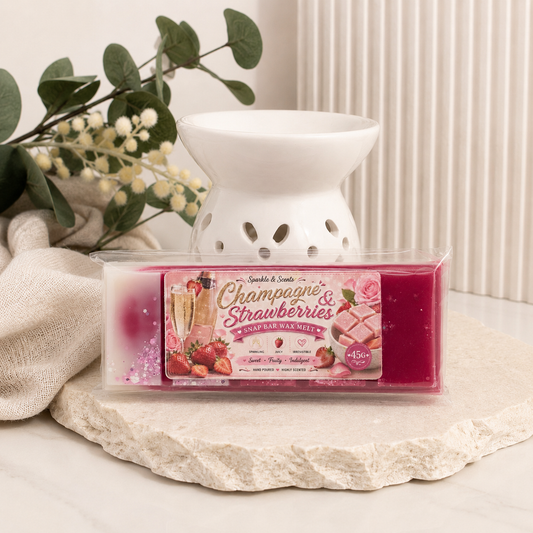 Wax melt container labeled 'Bubbles& Strawberries' with a decorative lamp on a neutral background.