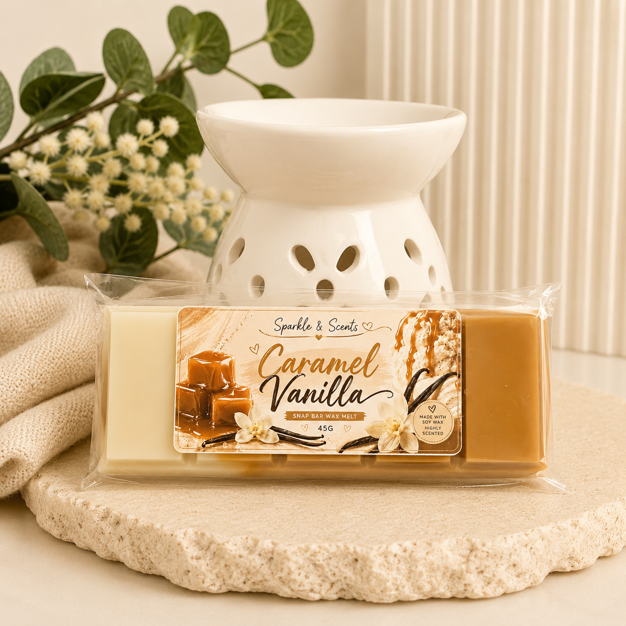 Caramel Vanilla wax melt package with a white wax warmer on a stone surface.