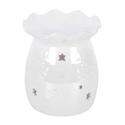 A white ceramic wax warmer with a scalloped rim, featuring embossed floral patterns and star-shaped cutouts that reveal a warm interior glow.