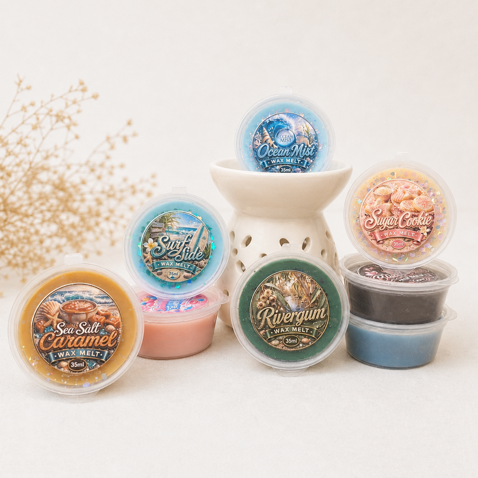 Collection of wax melts with various scents and designs on a white surface.