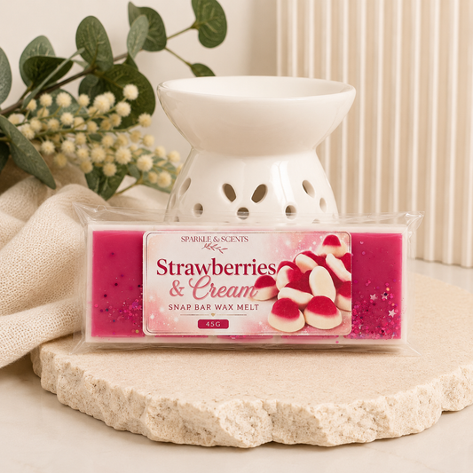 Strawberries & Cream wax melt with a white warmer on a decorative surface.