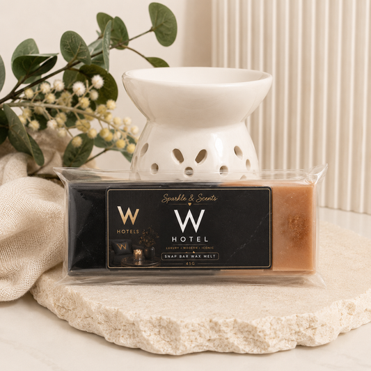 W Hotel wax melt packaging with a white wax warmer on a neutral background