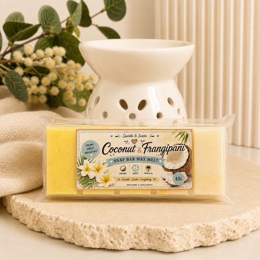 Coconut and Frangipani wax melt bar with packaging on a decorative surface.