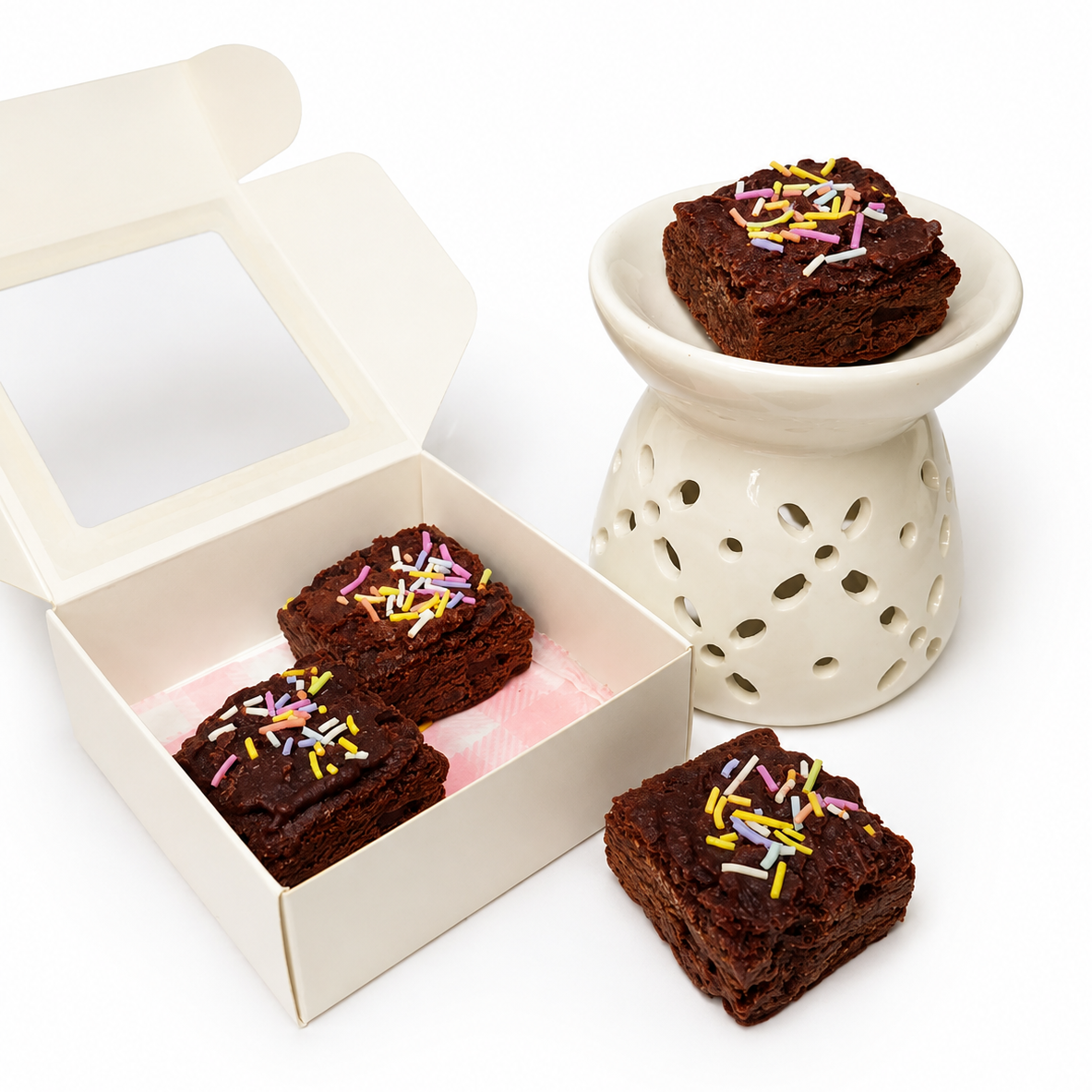 Brownies with sprinkles in a box and on a white surface